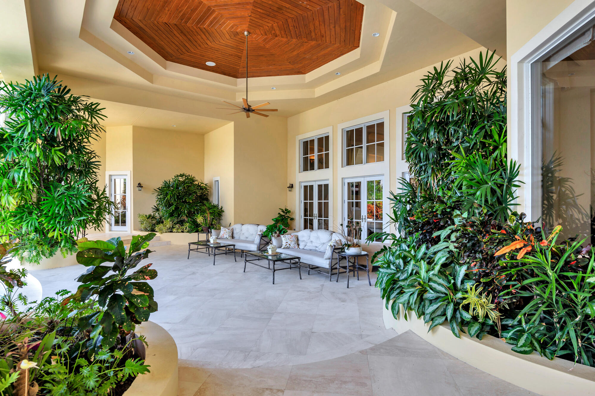 19223 North Riverside Drive Tequesta, FL 33469 - Photo 46 of 83 a view of a patio with plants and table and chairs under an umbrella