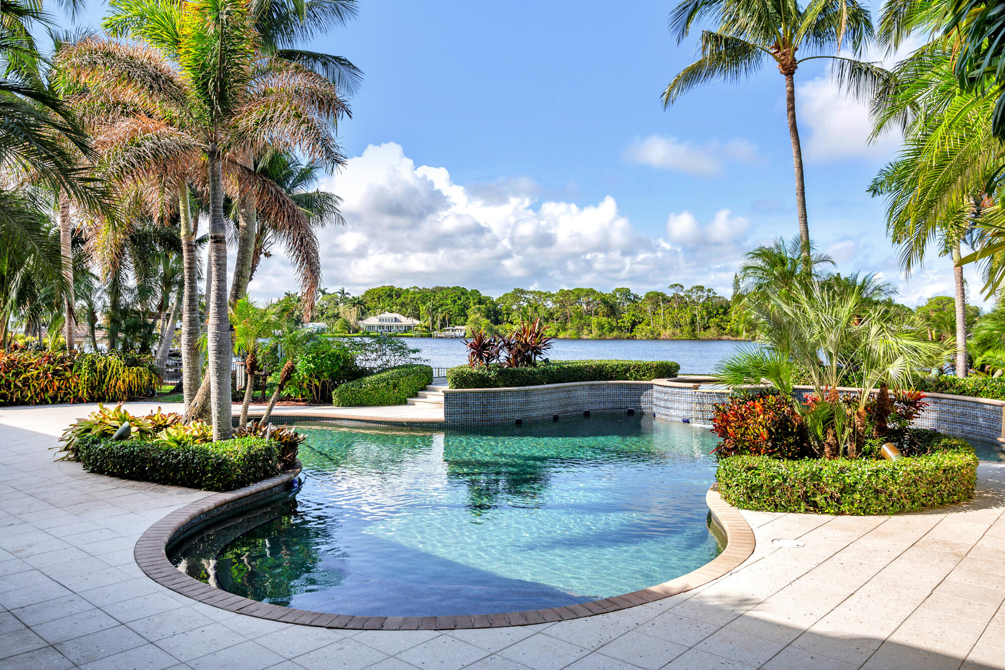 19223 North Riverside Drive Tequesta, FL 33469 - Photo 55 of 83 a view of a house with a yard potted plants