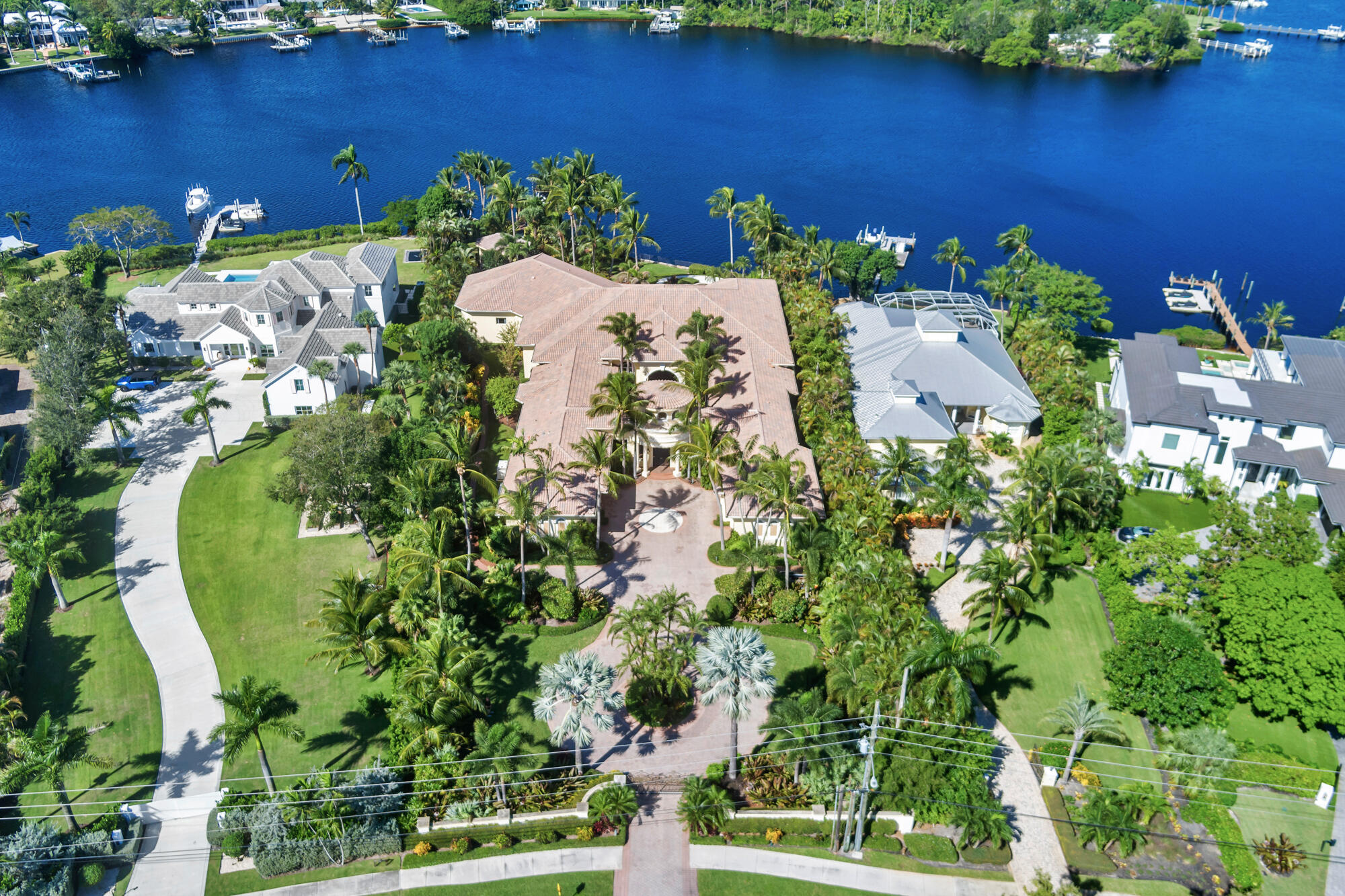 19223 North Riverside Drive Tequesta, FL 33469 - Photo 68 of 83 an aerial view of a house with a yard and lake view