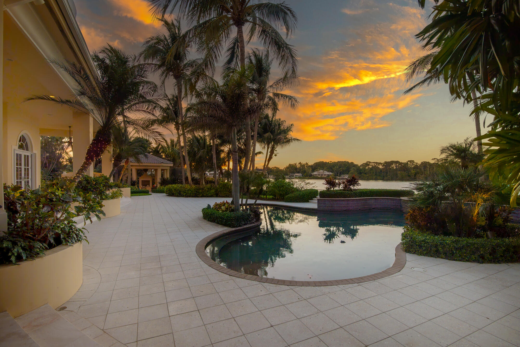 19223 North Riverside Drive Tequesta, FL 33469 - Photo 73 of 83 a view of a swimming pool with a garden