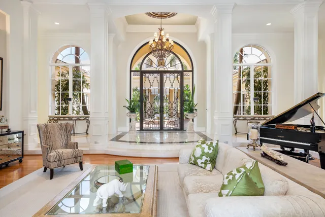 a living room with furniture and a chandelier