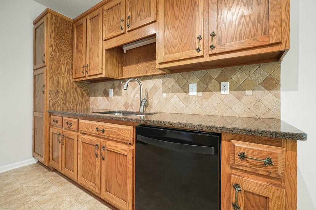 710 Bedford Trace Canton, GA 30114 - Photo 12 of 44 a kitchen with granite countertop cabinets stainless steel appliances granite counter tops and a window