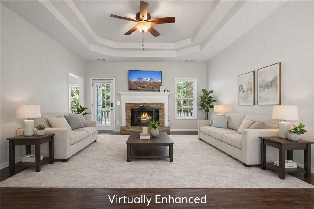 710 Bedford Trace Canton, GA 30114 - Photo 2 of 44 a living room with furniture a fireplace and a flat screen tv