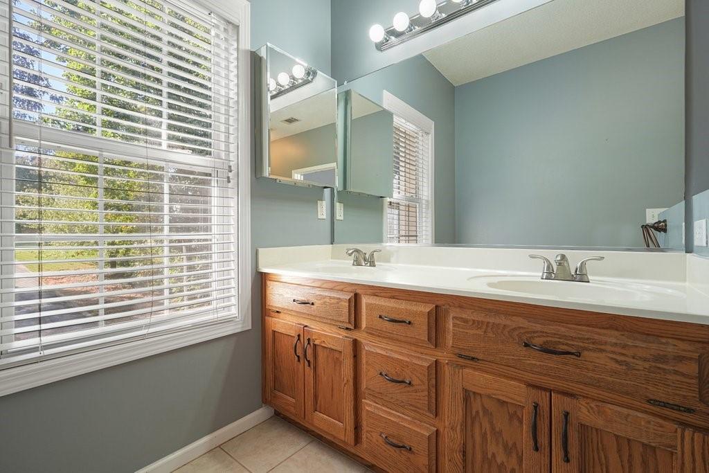 710 Bedford Trace Canton, GA 30114 - Photo 21 of 44 a bathroom with a granite countertop sink mirror and a window