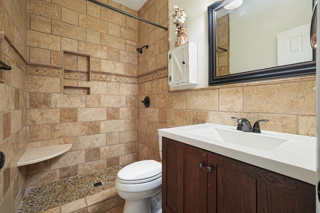 710 Bedford Trace Canton, GA 30114 - Photo 26 of 44 a bathroom with a sink a toilet and shower