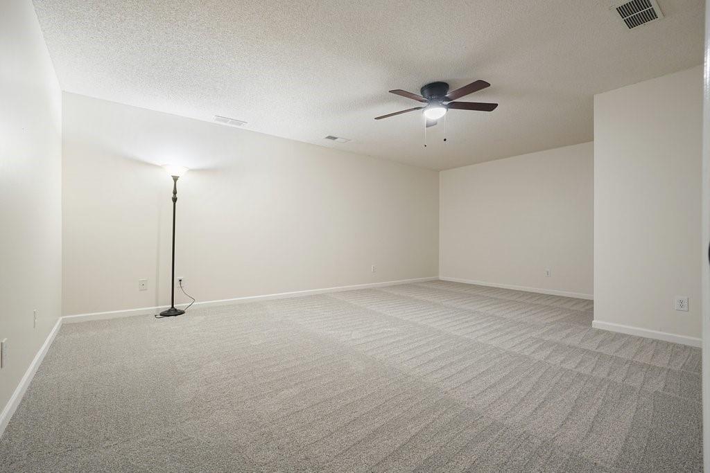 710 Bedford Trace Canton, GA 30114 - Photo 29 of 44 an empty room with a ceiling fan and window