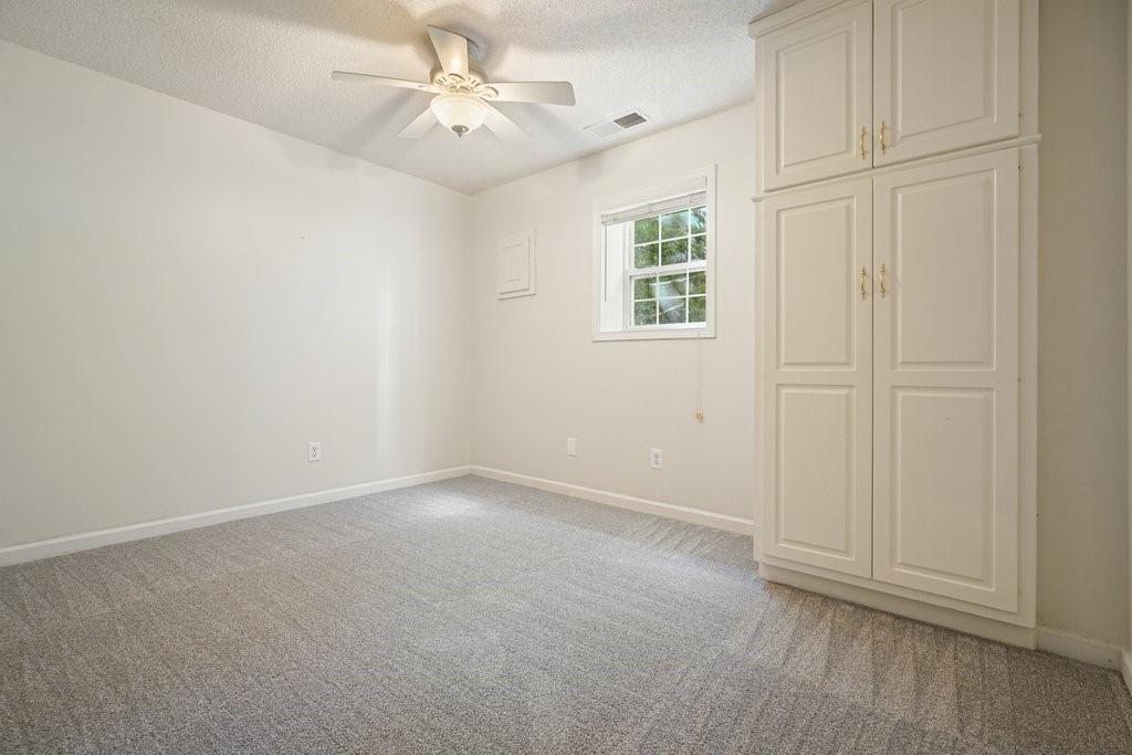 710 Bedford Trace Canton, GA 30114 - Photo 32 of 44 an empty room with windows and fan