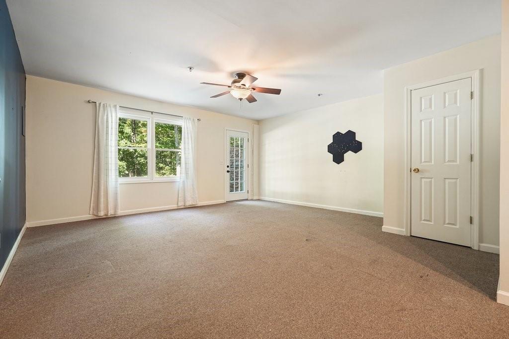 710 Bedford Trace Canton, GA 30114 - Photo 35 of 44 an empty room with windows and ceiling fan