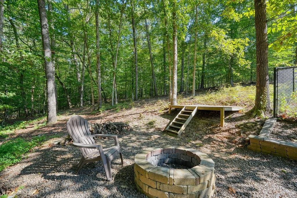 710 Bedford Trace Canton, GA 30114 - Photo 37 of 44 a view of a patio with table and chairs potted plants with large tree