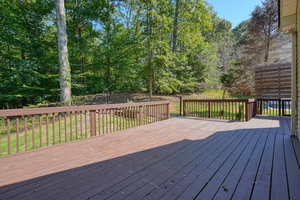 710 Bedford Trace Canton, GA 30114 - Photo 40 of 44 a view of house with deck outdoor seating and trees in the background