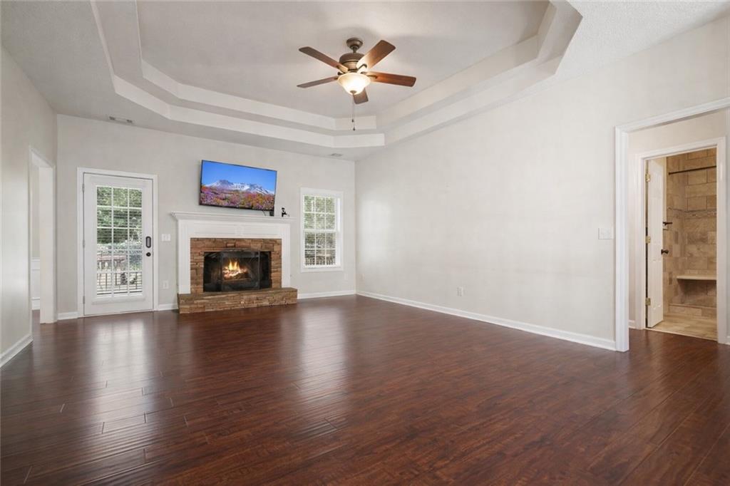 710 Bedford Trace Canton, GA 30114 - Photo 9 of 44 an empty room with furniture a fireplace and wooden floor