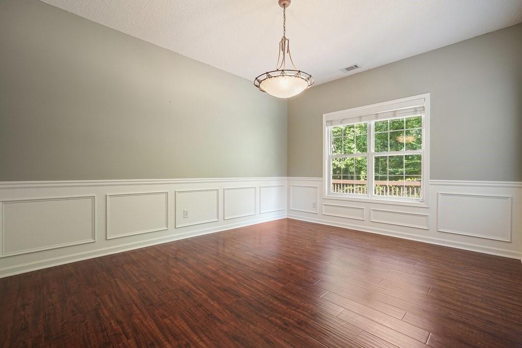 710 Bedford Trace Canton, GA 30114 - Photo 10 of 44 a view of an empty room with wooden floor and a window
