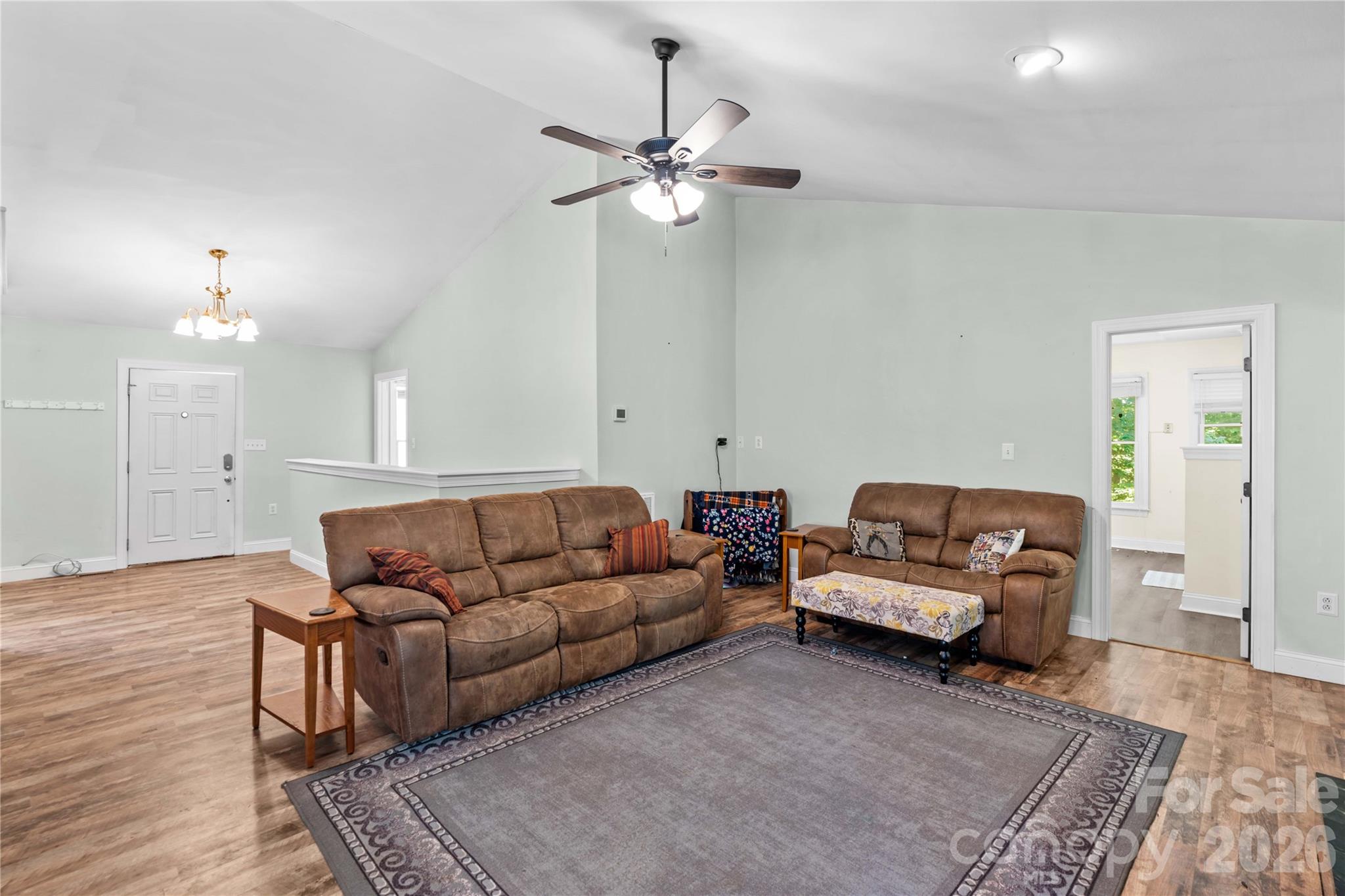 711 Spring Pointe Drive Stony Point, NC 28678 - Photo 6 of 47 a living room with furniture and a chandelier