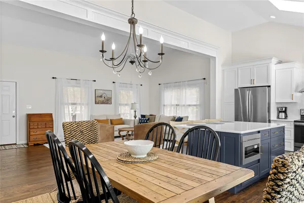 a large kitchen with a table and chairs