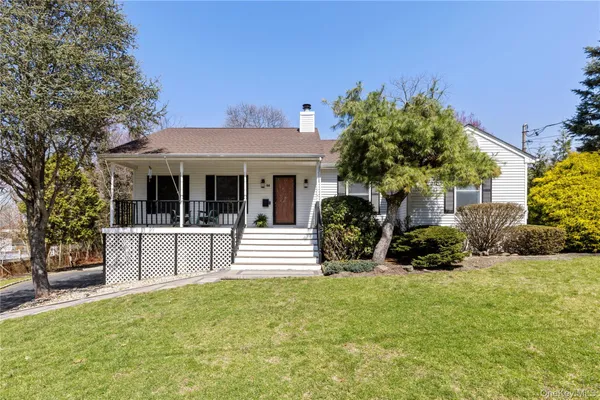 a view of a house with a yard and sitting area