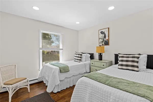 a bedroom with two beds and a window