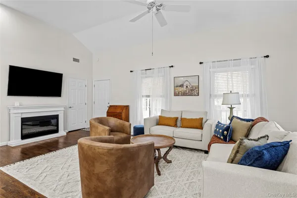 a living room with furniture fireplace and flat screen tv