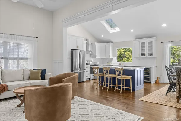 a living room with furniture dining table and a large window