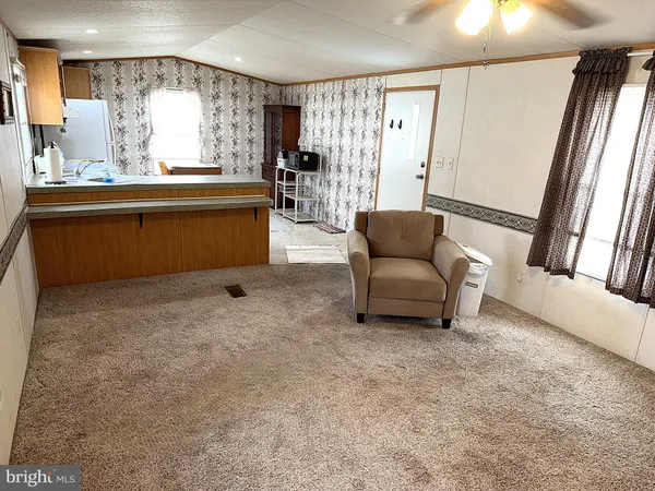 a living room with furniture and large windows