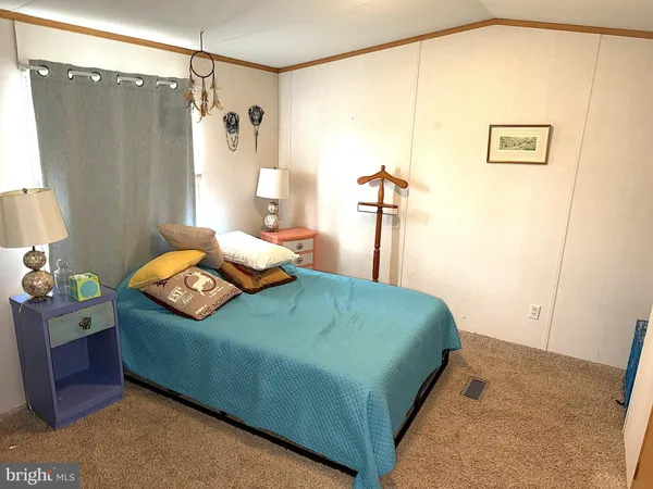 a bedroom with a bed and a table