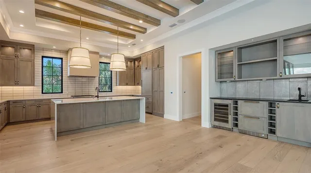 a view of a room with wooden floor and a ceiling fan