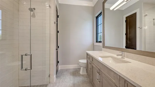 a spacious bathroom with a mirror sink and vanity