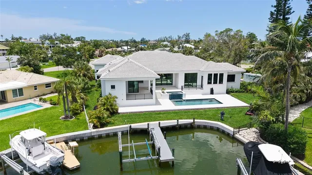 an empty room with wooden floor fireplace and windows