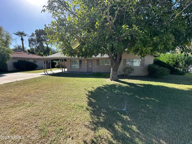 a house view with swimming pool in front of it