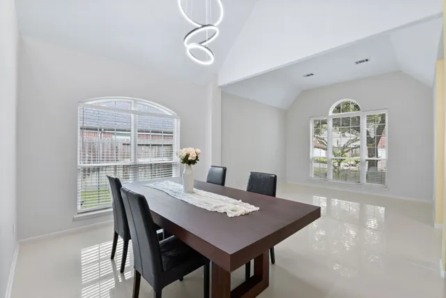 a view of a dining room with a table and chairs