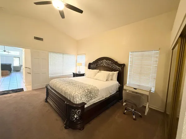 a spacious bedroom with a bed and a window