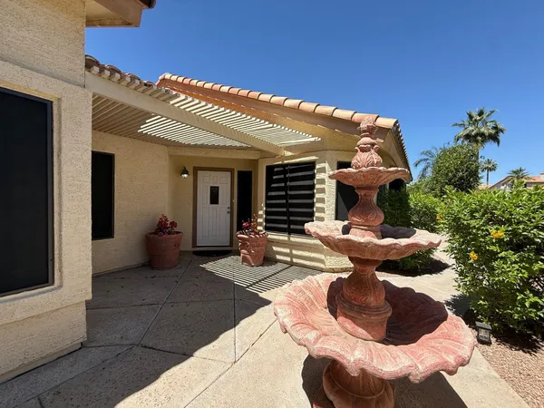 a view of a patio with couches and potted plants