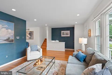 a living room with furniture and a lamp