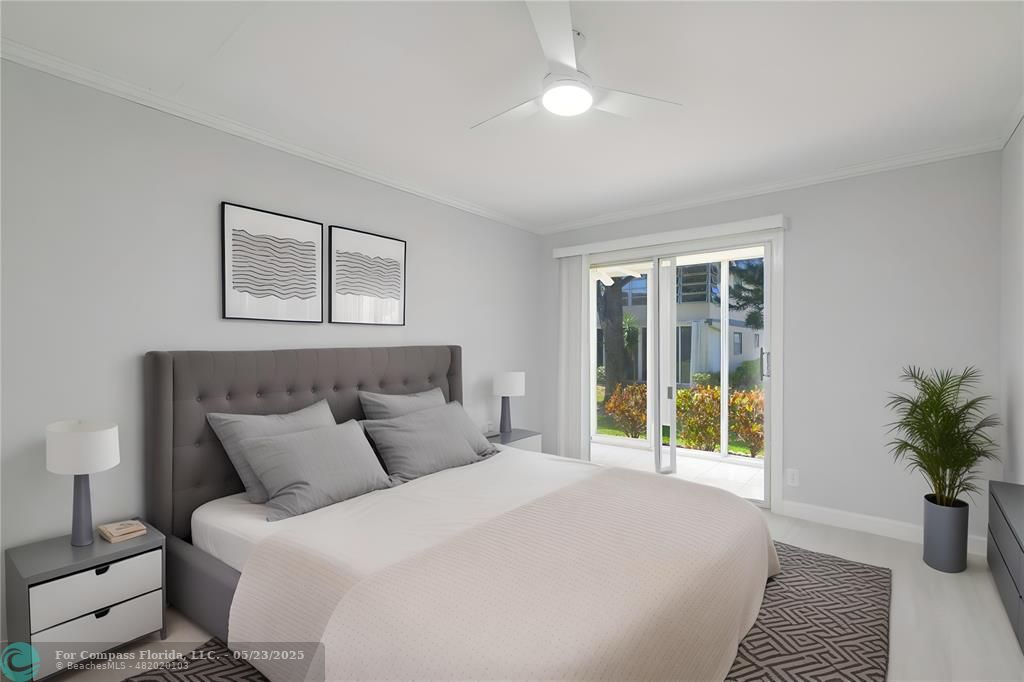 633 Brittany K, Unit 633 Delray Beach, FL 33446 - Photo 12 of 19 a bedroom with a large bed and a potted plant