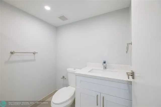 a bathroom with a sink a toilet and vanity