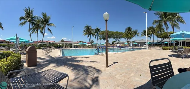 a view of a swimming pool with a table and chairs