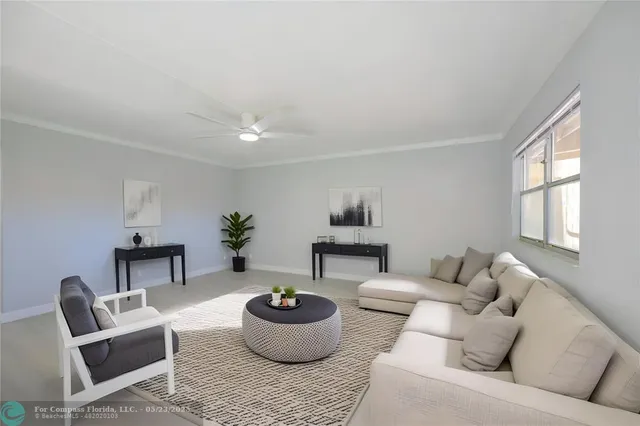a living room with furniture and a potted plant