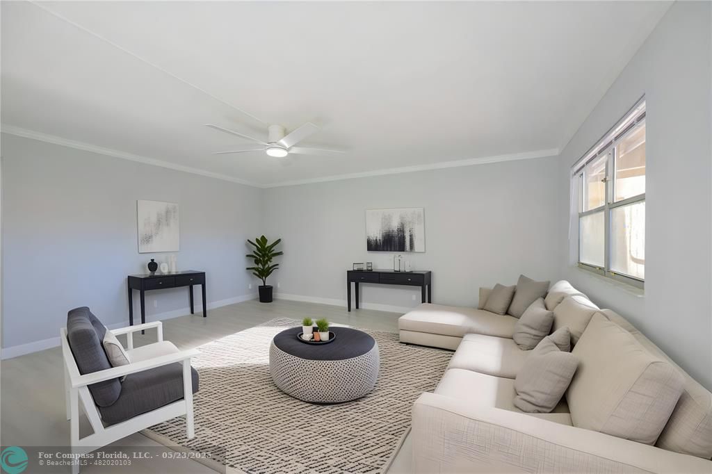 633 Brittany K, Unit 633 Delray Beach, FL 33446 - Photo 4 of 19 a living room with furniture and a potted plant