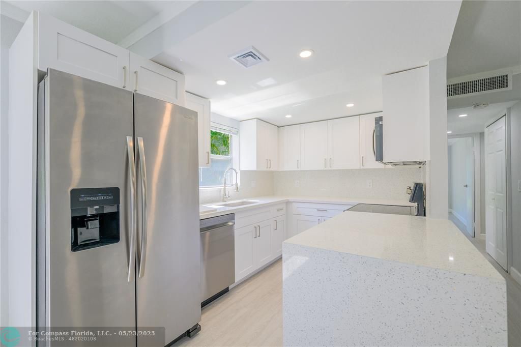 633 Brittany K, Unit 633 Delray Beach, FL 33446 - Photo 5 of 19 a kitchen with a refrigerator a sink and dishwasher