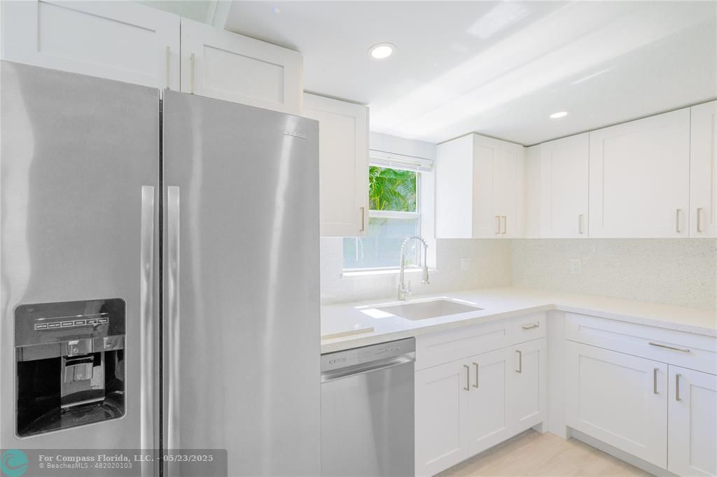 633 Brittany K, Unit 633 Delray Beach, FL 33446 - Photo 7 of 19 a kitchen with a sink and refrigerator