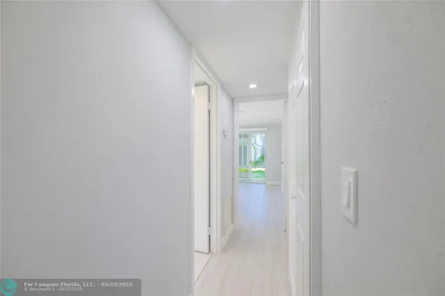 a view of hallway with bathroom
