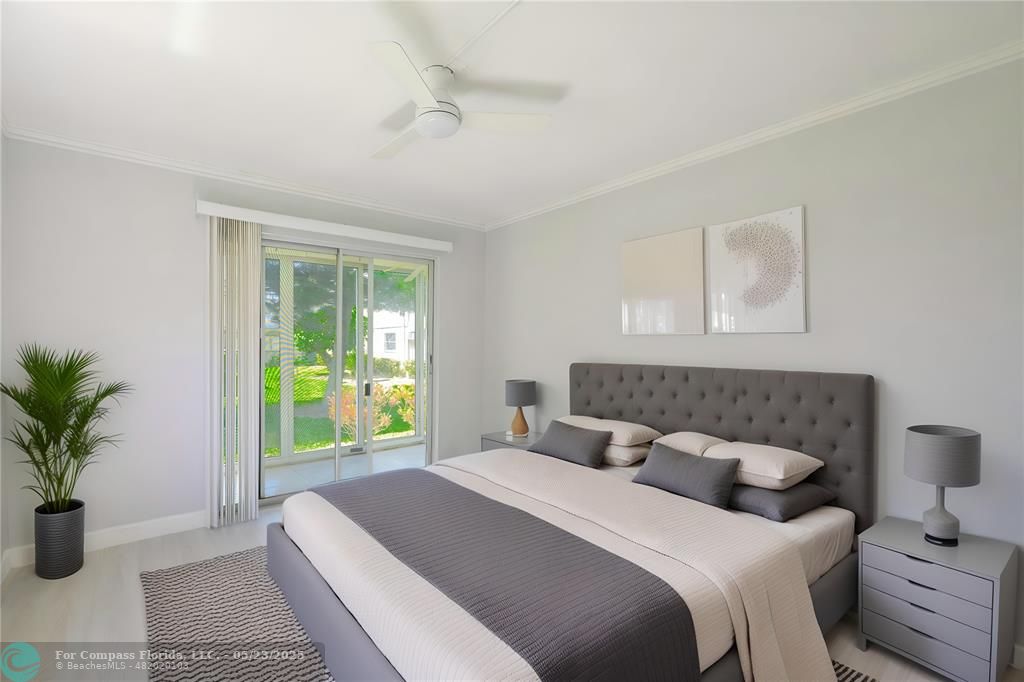 633 Brittany K, Unit 633 Delray Beach, FL 33446 - Photo 10 of 19 a bedroom with a bed and a potted plant