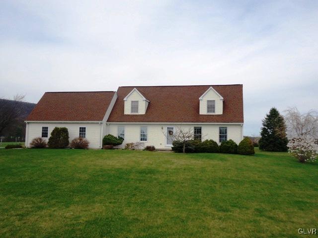 7919 Springhouse Road New Tripoli, PA 18066 - Photo 4 of 22 a house that is sitting in the grass with large trees and windows