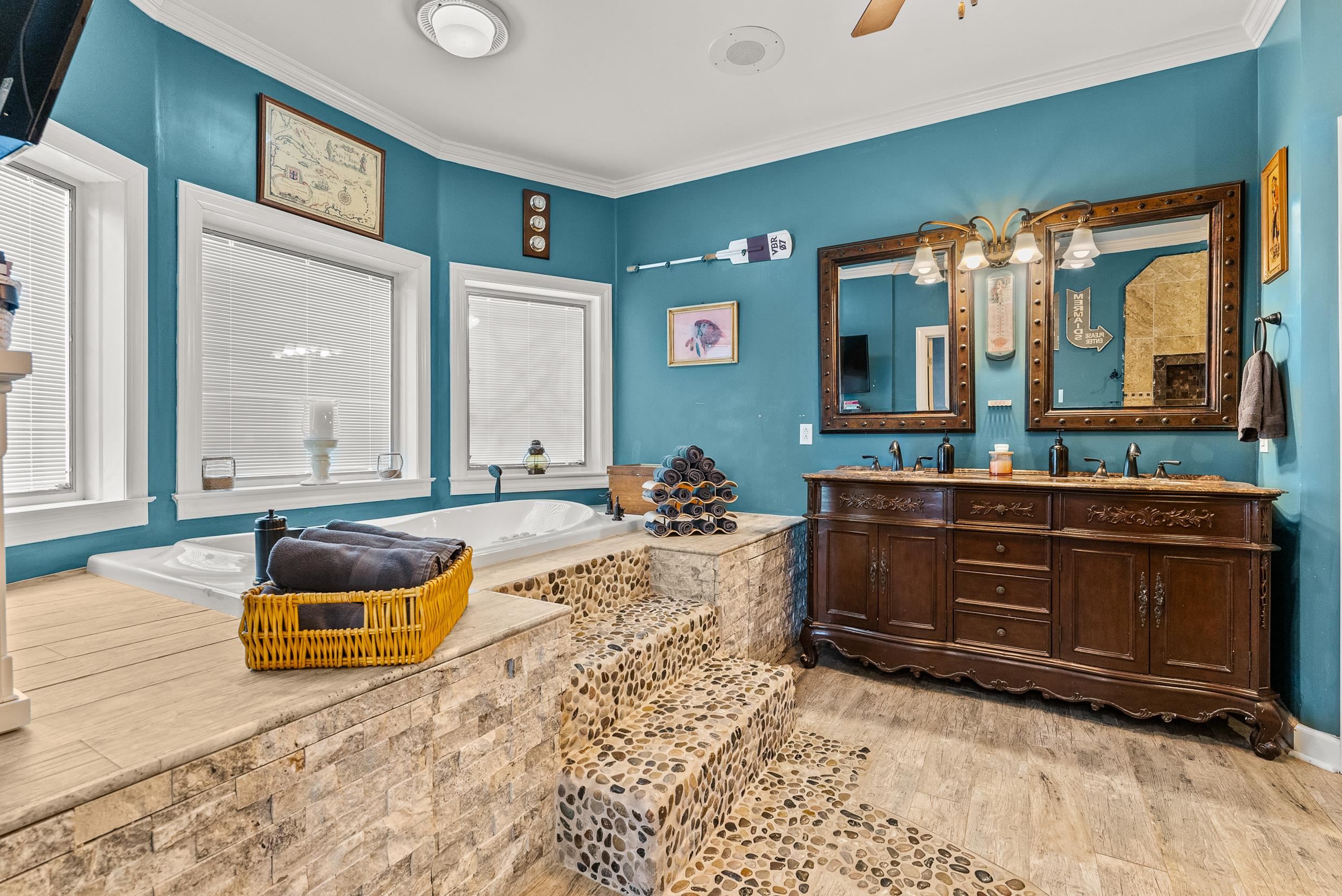 1459 C Vassar Road Pope, MS 38658 - Photo 29 of 40 Bathroom with double vanity, crown molding, a garden tub, and wood finished floors