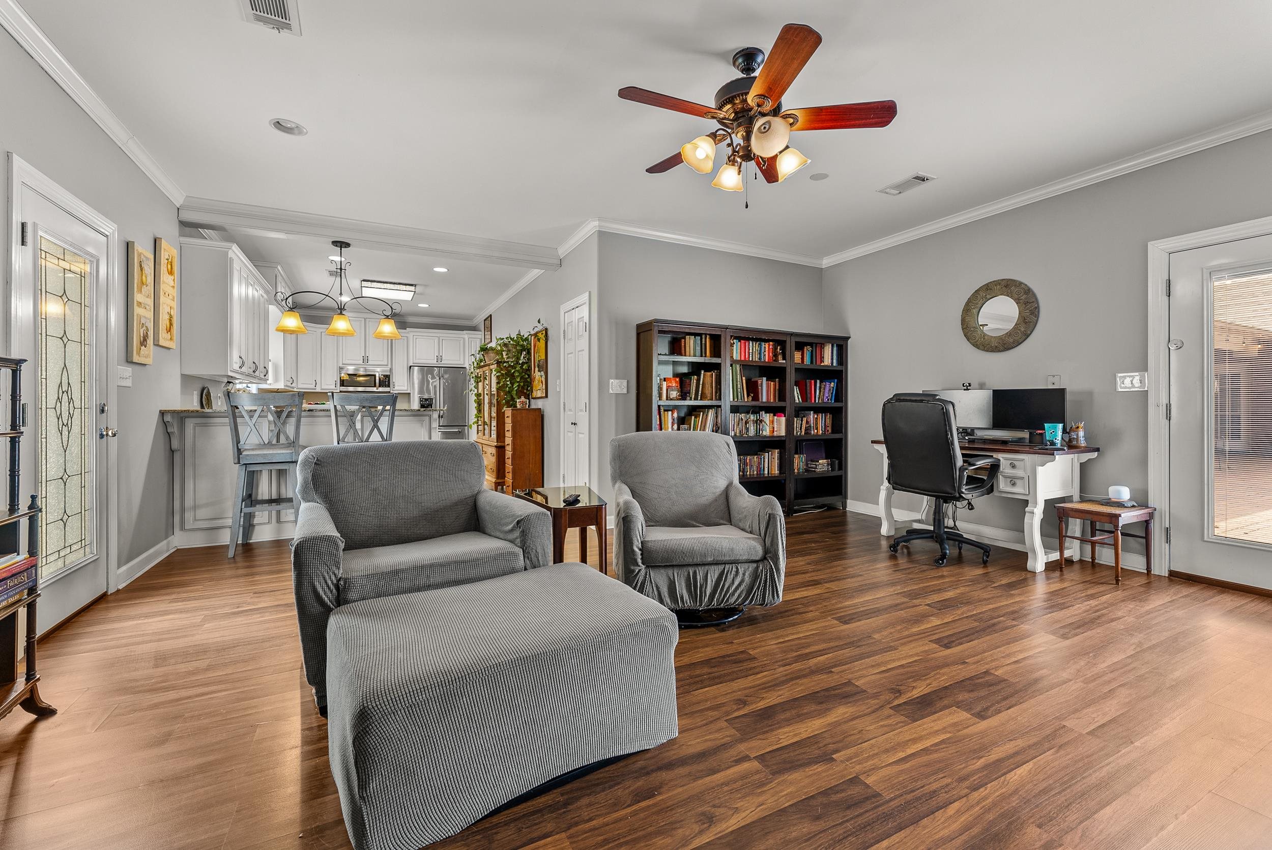 1459 C Vassar Road Pope, MS 38658 - Photo 36 of 40 Living area featuring a ceiling fan, visible vents, ornamental molding, and wood finished floors