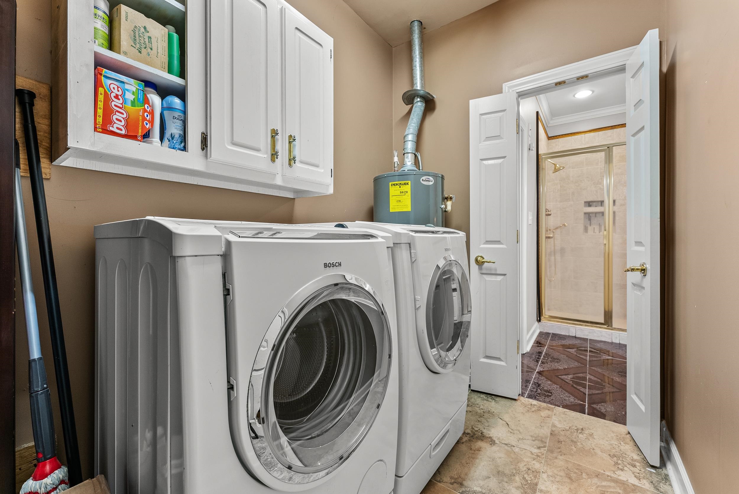 1459 C Vassar Road Pope, MS 38658 - Photo 40 of 40 Washroom featuring water heater, recessed lighting, baseboards, washing machine and clothes dryer, and cabinet space