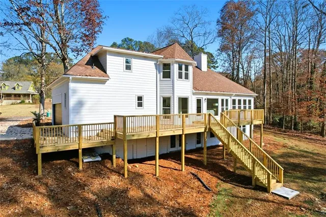 a view of a house with a yard and wooden fence