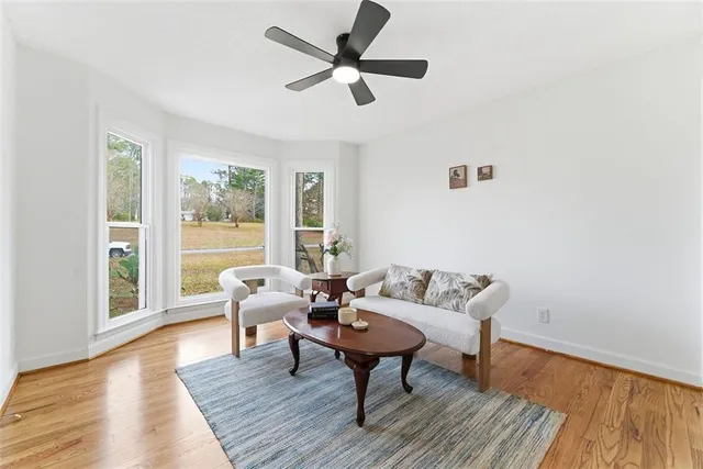a living room with furniture and a wooden floor