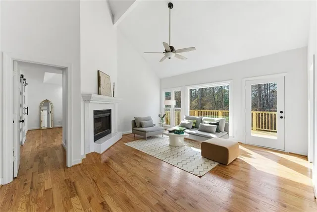 a living room with furniture a fireplace and a floor to ceiling window