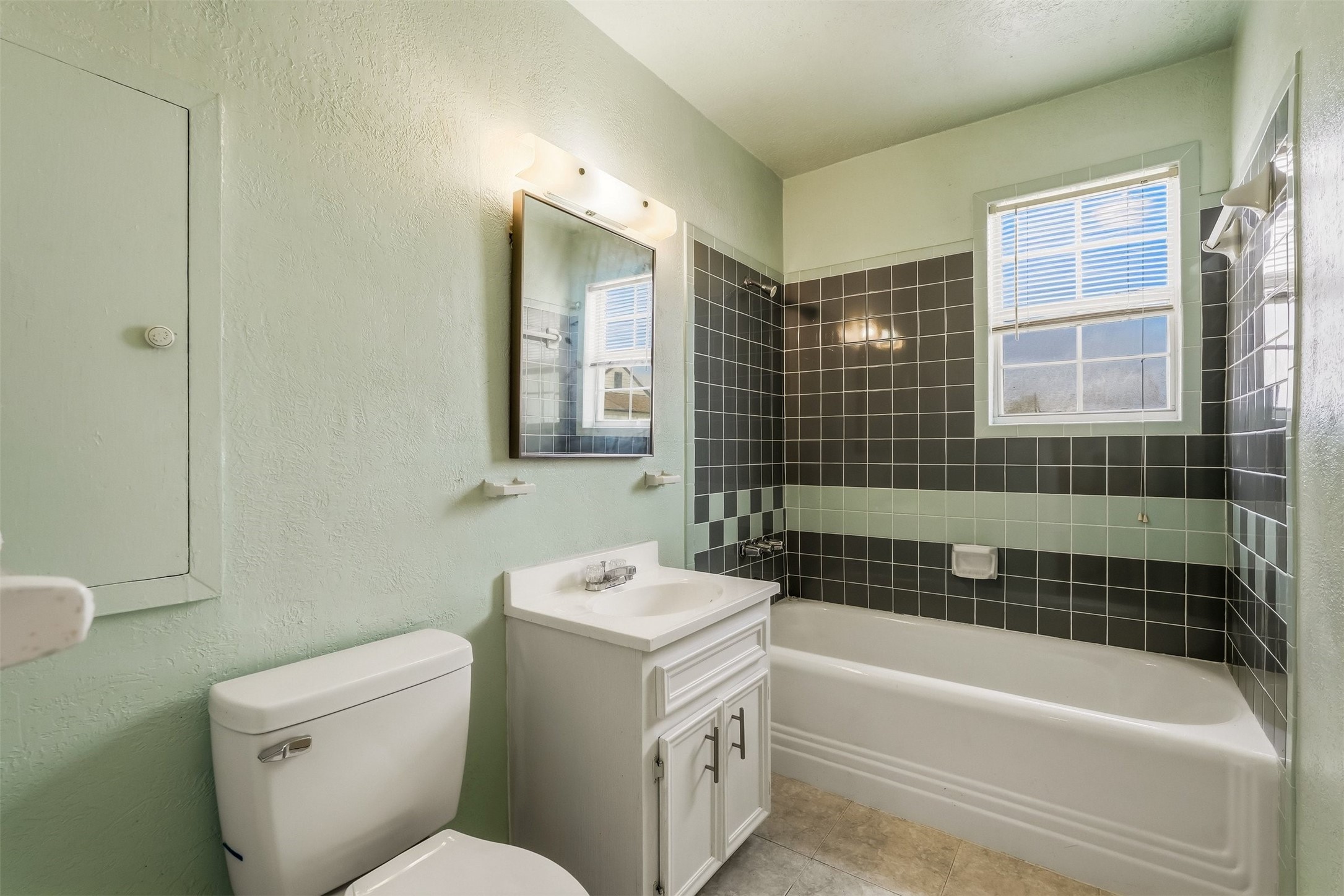 7215 Apache Street Houston, TX 77028 - Photo 17 of 20 a bathroom with a sink a toilet and shower