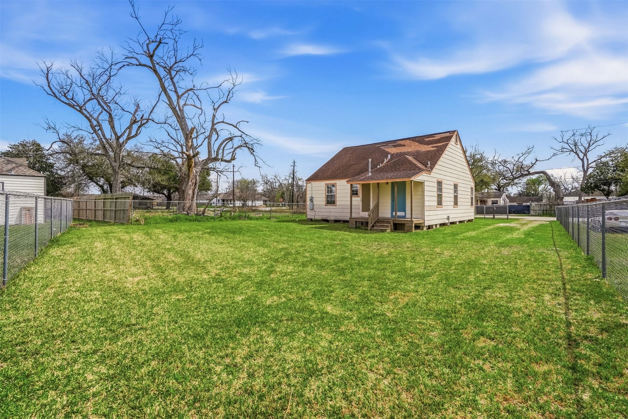 7215 Apache Street Houston, TX 77028 - Photo 19 of 20 a front view of house with yard and trees in the background